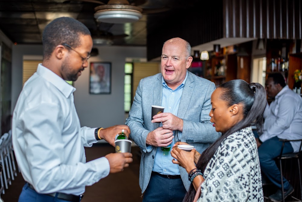 Guests connecting over coffee at a Friends of Ireland Ghana gathering.