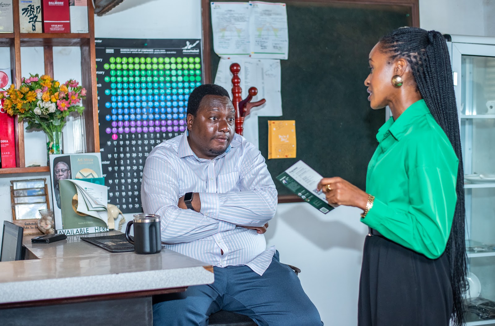 A member sharing information with a guest at a Friends of Ireland Ghana event.